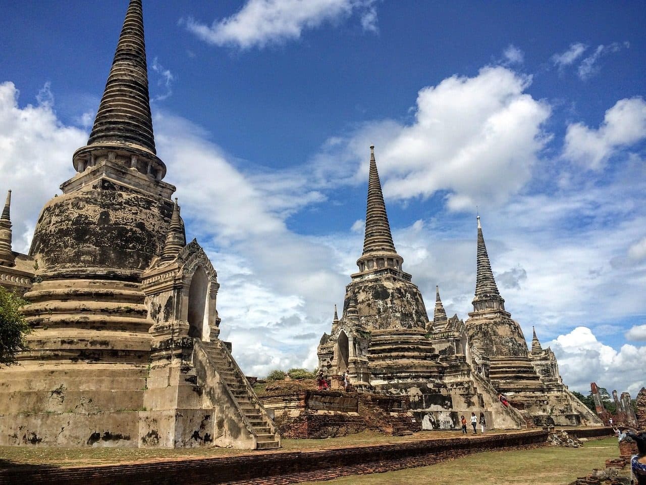 Three bell-shaped chedis among brick ruins in Ayutthaya