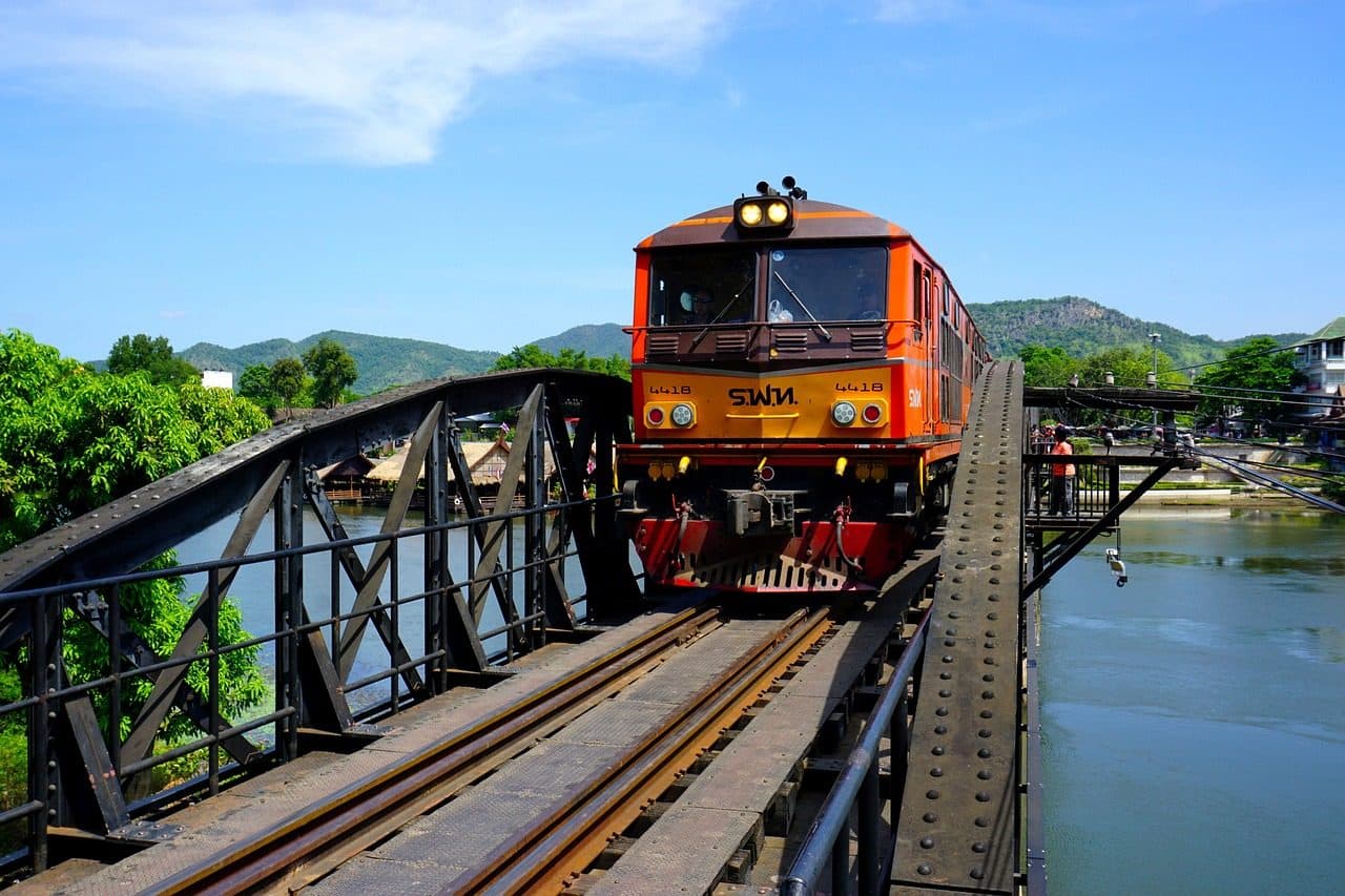 A train crossing the Death Railway bridge over the River Kwai in Kanchanaburi